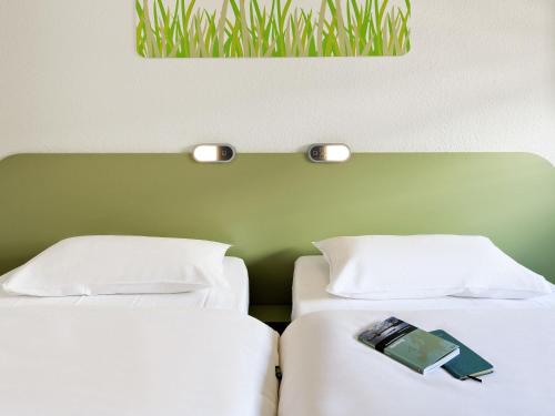 Ένα ή περισσότερα κρεβάτια σε δωμάτιο στο ibis budget Dresden City