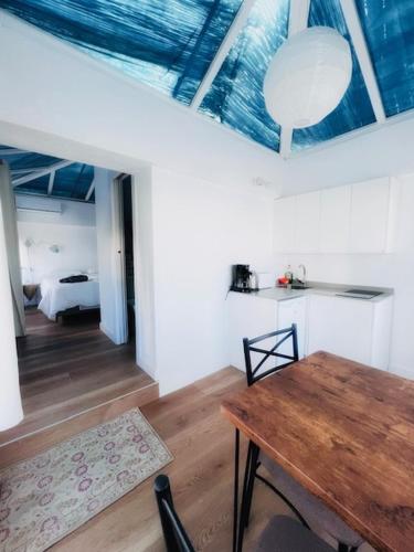 a room with a wooden table and a bed at El Beaterio Apartments in Tarifa