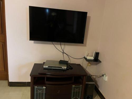 a flat screen tv hanging on a wall at Paradise in najjera in Kampala