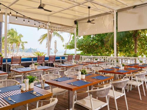 a row of tables and chairs in a restaurant at Pullman Pattaya Hotel G in Pattaya North