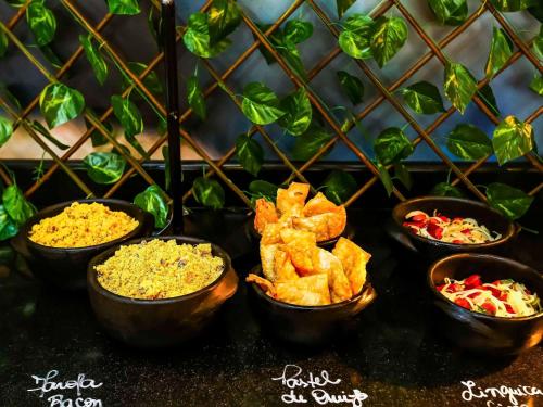 a group of bowls of food on a table at ibis Rio de Janeiro Botafogo in Rio de Janeiro