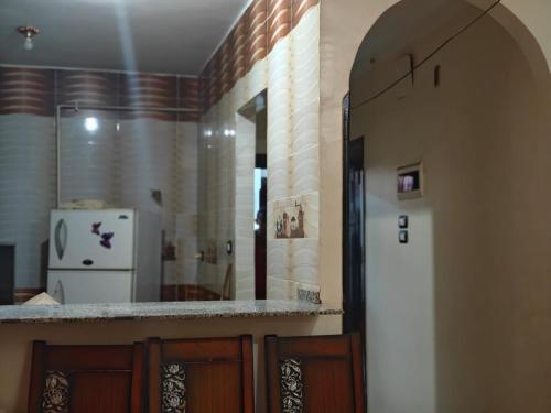 a kitchen with a counter and a refrigerator at Family apartment LUXOR in Jazīrat al ‘Awwāmīyah