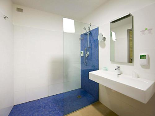 a bathroom with a sink and a shower with a mirror at ibis Styles Catania Acireale in Acireale