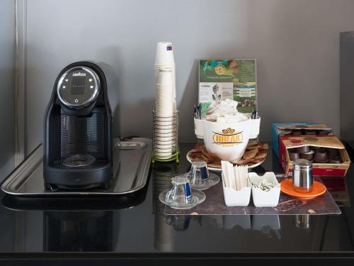 a table with a coffee maker and a microwave at ibis Styles Catania Acireale in Acireale