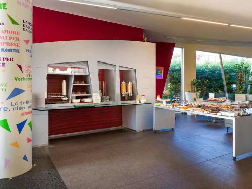 a bakery with several tables of food on display at ibis Styles Catania Acireale in Acireale