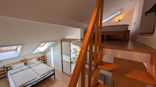 a small room with a bunk bed and a staircase at Malt & Monarch Apartment in Bratislava