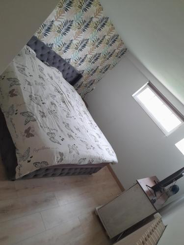 a bedroom with a bed with a pillow and a window at Saint Malo - Chambre cocooning- A la campagne in Saint Malo