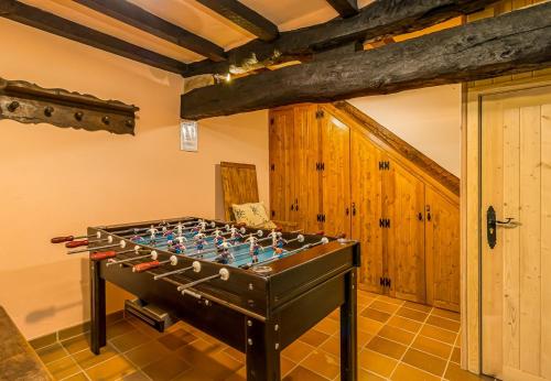 a room with a foosball table in the middle of a room at Casa de piedra en el corazón de Potes in Potes