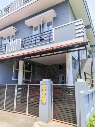 a yellow fire hydrant in front of a house at Misty Homes in Madikeri