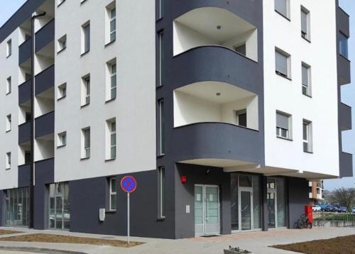a large building with a blue and white facade at Apartman Sofija in Teslić