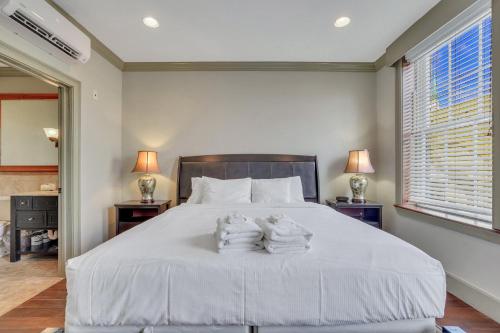 a bedroom with a bed with towels on it at McDonough's Inn Unit 1 by Lucky Savannah in Savannah