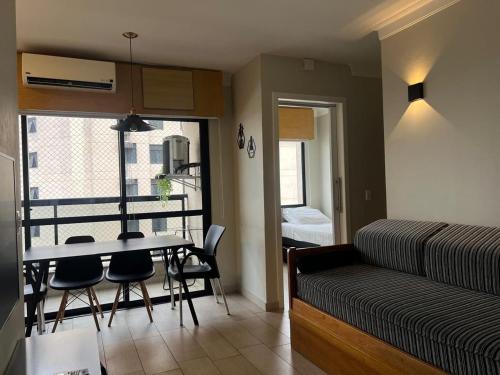 a room with a table and chairs and a bed at Airfamily Congonhas in Sao Paulo