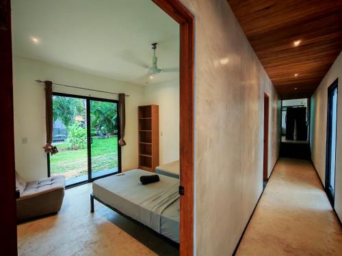 a bedroom with a bed and a large window at Pyramid Tamarindo Luxury Hotel in Tamarindo