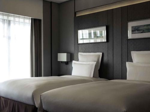 Postel nebo postele na pokoji v ubytování Pullman Shanghai Xuhui