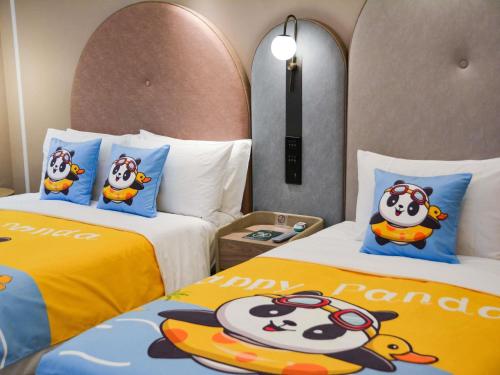a hotel room with two beds with hello kitty pillows at Mercure Beijing Downtown in Beijing