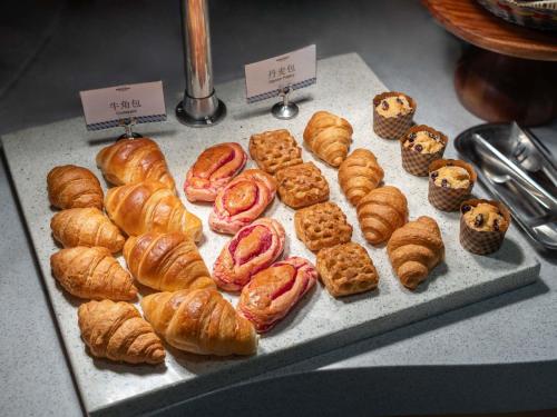 a display of croissants and pastries on a tray at Mercure Beijing Downtown in Beijing