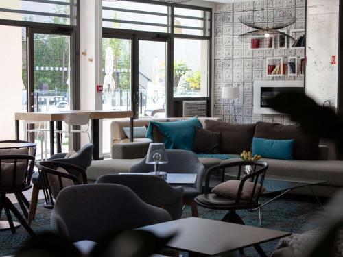 a living room with a couch and chairs at Novotel Avignon Centre in Avignon