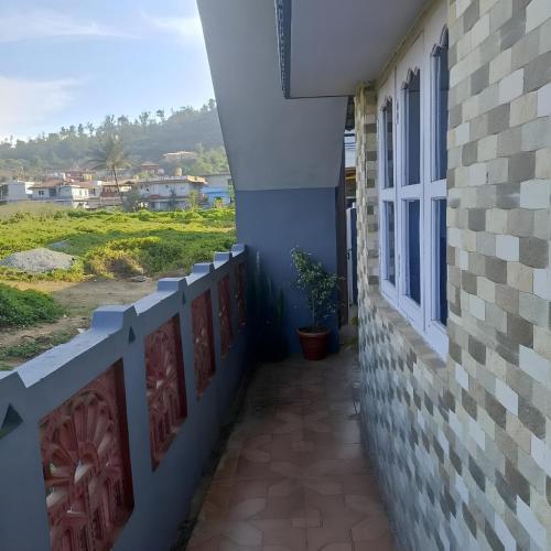 a balcony of a house with a view of the ocean at Misty Homes in Madikeri