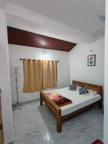 a bedroom with a large bed in a room at Misty Homes in Madikeri