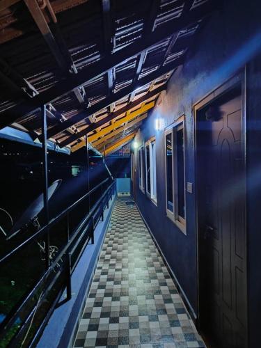 a train station with a platform and a subway train at Misty Homes in Madikeri