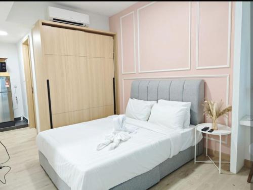 a bedroom with a bed with white shoes on it at The Luxe By klcc infinitum in Kuala Lumpur