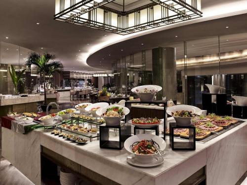 a buffet line with many different types of food at Pullman Hanoi in Hanoi