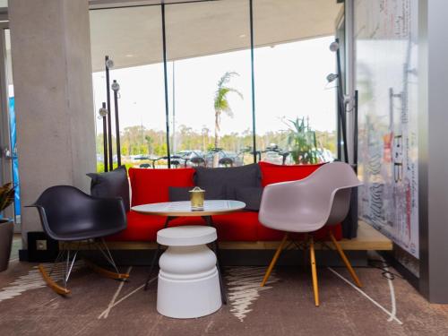 a table and two chairs in front of a window at Ibis Casanearshore in Casablanca
