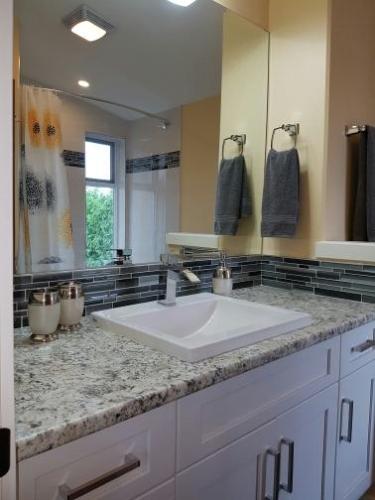 a bathroom with a sink and a large mirror at Sunrise Terraces in Ladysmith
