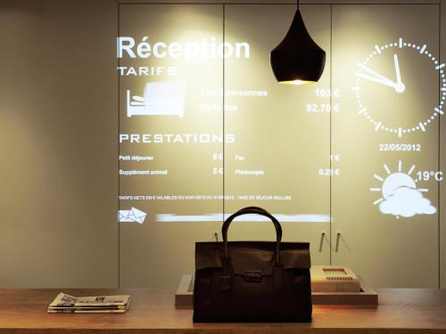 a bag sitting on a table in front of a window at Ibis Lleida in Lleida