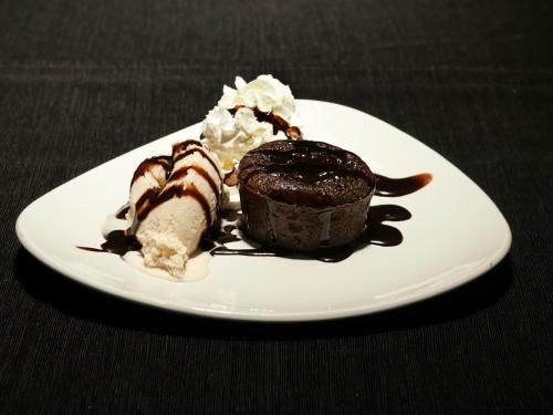 a plate with a chocolate cake and ice cream at Ibis Budget Lleida in Lleida