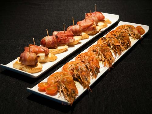 three plates with different types of food on them at Ibis Budget Lleida in Lleida