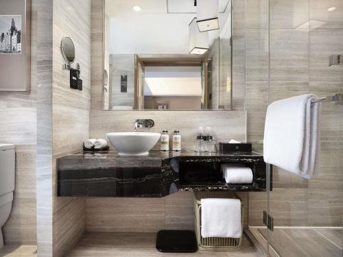 a bathroom with a sink and a mirror at Pullman Shanghai Jing'an-Jing'an district, downtown railway station, traffic hub, easy to travel Shanghai in Shanghai