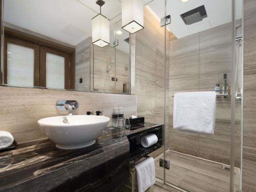 a bathroom with a sink and a shower at Pullman Shanghai Jing'an-Jing'an district, downtown railway station, traffic hub, easy to travel Shanghai in Shanghai