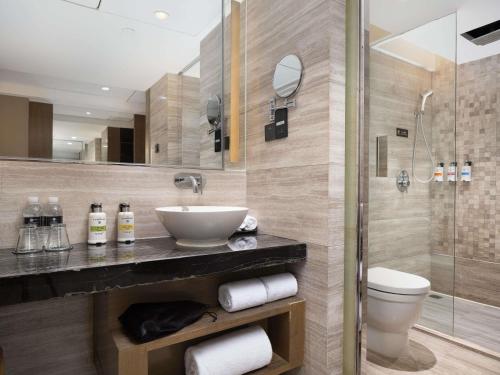 a bathroom with a sink and a shower at Pullman Shanghai Jing'an-Jing'an district, downtown railway station, traffic hub, easy to travel Shanghai in Shanghai