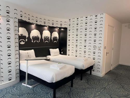 a room with two beds with skulls on the wall at Ibis Styles Liverpool Centre Dale Street - Cavern Quarter in Liverpool