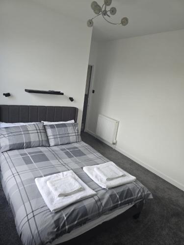 a bedroom with a bed with two towels on it at The Nodrog Escape in Saint Abbs