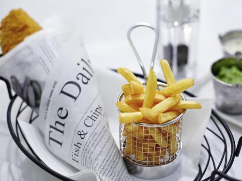 a cup of french fries sitting on a table at Ibis Styles Liverpool Centre Dale Street - Cavern Quarter in Liverpool