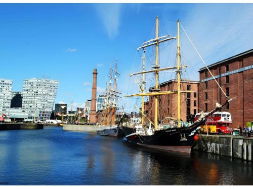 a large boat docked in a river in a city at Ibis Styles Liverpool Centre Dale Street - Cavern Quarter in Liverpool