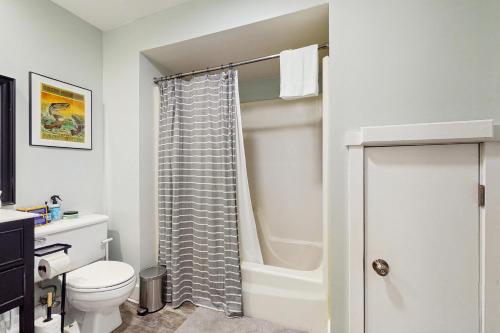 a bathroom with a toilet and a shower at Mill Run 3C in Quechee