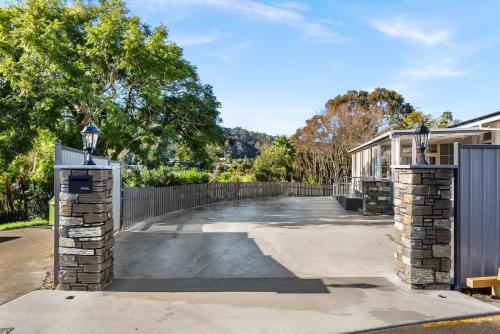 a driveway of a house with a fence at Deluxe Queen Room at Wolfe Street in Whangarei