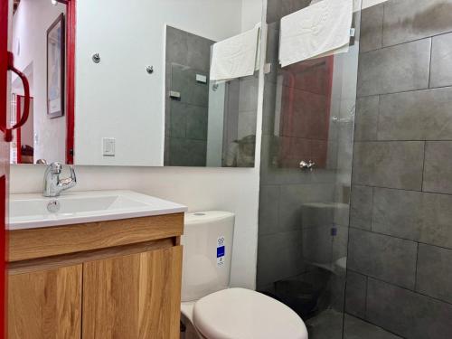 a bathroom with a toilet and a sink and a shower at Finca cafetera para descanso in Fredonia