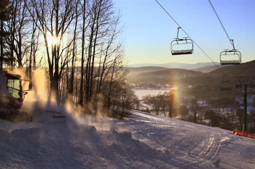 a snow covered ski slope with a ski lift at Mill Run 3C in Quechee