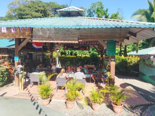 a group of people sitting at a restaurant at New Caribe Point in Cahuita