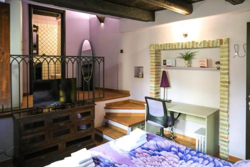 a living room with a bed and a desk at Residenza Sant'Andrea in Campobasso