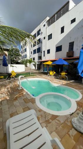 a swimming pool in front of a building at Pousada Lá na Praia Maragogi in Maragogi