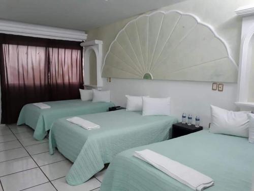 Ένα ή περισσότερα κρεβάτια σε δωμάτιο στο Hotel DI-AN