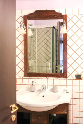 a bathroom with a sink and a mirror at Residenza Sant'Andrea in Campobasso