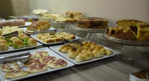 a buffet with many different types of pastries and cakes at Hotel Tropical in Porto Velho