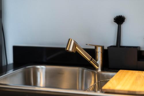 a kitchen sink with a faucet and a wooden cutting board at Zielo Rentals Palma ,Private balcony, Rooftop Walk to Zocalo in Mexico City