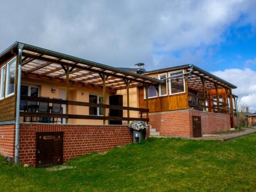 a large brick house with a roof at Hideaway Near Castle Views in Blankenburg